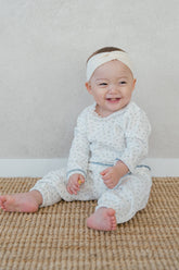 Baby girl in Avauma Spring Cream Ivory pajama – cozy floral sleepwear with soft cuffs